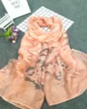 Close-up detail view of light peach burnout floral pattern scarf with soft gradient texture - Snow Bud