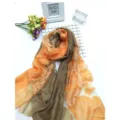 Detail showing the intricate cut-flower floral pattern on a color-block silk scarf - 75x200cm / Orange Khaki
