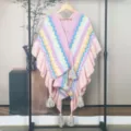 Detailed macro view of pink zigzag knitted poncho shawl with tassels and ruffles - Tops / Pink