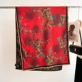 Vintage red mulberry silk scarf with vibrant orange fruit prints hanging on a rack - 180cm / Retro Red Fruit Leaves (6)