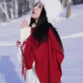 Elegant red winter scarf with tassels worn by a model in a snowy outdoor landscape scenery - 200*70cm / Burgundy