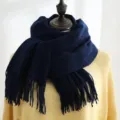 Detailed view of a thick navy blue winter scarf with decorative fringe on a mannequin. - 200*70cm / Navy Blue