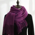 Detailed view of a thick purple winter scarf with elegant tassels on a mannequin - 200*70cm / Deep purple
