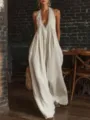 Close-up detail of a bohemian white loose jumpsuit featuring deep V-neck and lace trim - S / Jumpsuits / White