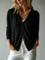 Close-up detail of a minimalist black button-down hooded cardigan featuring soft premium fabric - Black