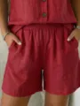 Close-up of red cotton linen shorts featuring elastic waist and side pockets - S / Bottoms / Red