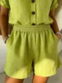 Detailed view of women's lime green cotton linen shorts featuring elastic waist and pockets - Green
