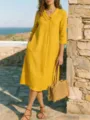 Detail of elegant yellow summer dress featuring French lapel and functional buttons - S / Yellow