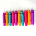 Macro view of ten colorful 13mm pop tubes with vibrant corrugated texture and variety - Tubes 13.3*60 (Random Color 10 Pieces/Pack)