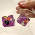 Two purple Halloween squishy toys with ghost and pumpkin designs in a clear plastic bag - Halloween Square Style / Halloween Purple Crystal Ice Cube