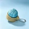 Close-up of 3D printed blue dumpling in a steamer basket toy keychain with fine textures. - Blue