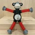 Stretchable pop tube monkey toy with suction cups in black and red colors. - Without Lights / Black Red