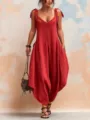 Detail of a loose summer red V-neck wide-leg jumpsuit showing bow straps and side pockets. - S / Set / Red