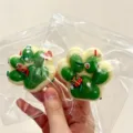 Festive green and white Christmas cat paw squishy stress relief toy held in hand - Christmas Decor Style / Christmas Green Cat Paw