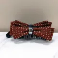 Detailed view of a brown polka dot banana hair clip with elegant crystal embellishment - Red Brown