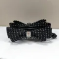 Elegant black polka dot bow hair banana clip with a sparkling clear crystal center - Black