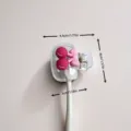 Detailed view showing the exact dimensions of the cherry-style portable toothbrush clip - White