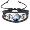 Macro view of a braided leather bracelet featuring a howling wolf cabochon - #01(Howling Wolf)