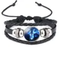 Close-up of braided leather bracelet with galaxy elephant glass cabochon charm - Black