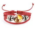 Macro view of a vibrant red braided leather elephant bracelet with a detailed glass cabochon - Red