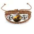 Detailed view of multilayer brown leather bracelet with an elephant sunset cabochon charm - Brown
