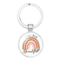 Close-up of a silver keychain pendant with a boho rainbow and motivational text. - 25mm White K / #02