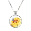 Macro shot of a circular glass pendant necklace with sunflower and butterfly detail - Sunflower Style #03 / 25mm