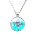 Detailed view of a 25mm round butterfly pendant with blue background and steel chain - Black and White Butterfly
