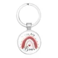 Detailed view of a circular metal keychain with a rainbow and 'You Are Brave' text. - 25mm White K / #06