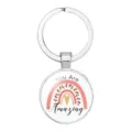 Close-up of circular silver-colored keychain with a rainbow and 'You Are Amazing' text - 25mm White K / Up House Balloon