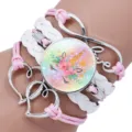 Macro detail of a multilayer unicorn cabochon bracelet with pink and white braided cords - Unicorn Style Ten / 25mm