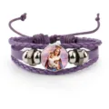 Macro view of purple cowhide leather bracelet with religious Madonna and Child charm - Purple
