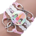 Close-up of children's multi-layered unicorn bracelet with pink and white cords. - Unicorn Style Twelve / 25mm