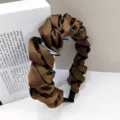 Close-up of brown ruffled satin bubble headband showing inner non-slip teeth - Coffee