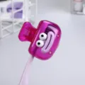 Close-up of portable cartoon toothbrush clip cover in transparent purple color. - Purple