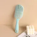 Mint green vented hairbrush for scalp massage and volumizing on a minimalist background - Sky Blue