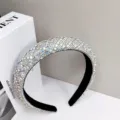Close-up macro view of a luxury wide headband fully encrusted with sparkling silver rhinestones - AB Diamond