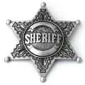 Detailed macro shot of an antique silver six-pointed sheriff star badge with relief text - Antique Pewter