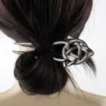 Macro detail view of a vintage silver Celtic knot hair stick securing a bun hairstyle - D-983 Style (D-983) / Antique Silver