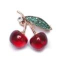Élégante broche cerise rouge avec strass verts et tige dorée pour la mode féminine - Style Perle Rouge Transparente avec Feuille en Strass Vert (D-1769)