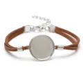 Macro detail of a 20mm round silver alloy bezel tray on a brown suede cord bracelet base - White K - Brown