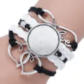 Close-up of handmade multi-layer braided bracelet with blank round gem tray and love charm - Black and White