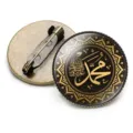 Detailed view of Islamic calligraphy brooch with bronze metal back and glass dome - Black Background Gold Calligraphy Style