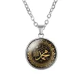 Detailed macro view of the circular glass cabochon pendant with golden Arabic calligraphy motif - Black and Gold Calligraphy