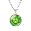 Detailed macro view of a green yoga mandala pendant necklace with intricate hexagram design - Green