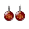Detailed macro view of red cabochon earrings featuring golden Arabic calligraphy art - Red Gold Calligraphy Style