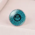 Macro view of an adjustable silver ring featuring cyan Arabic calligraphy on a blue glass cabochon. - Adjustable Open / Blue-Green Arabic Calligraphy