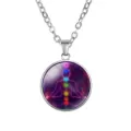 Close-up of silver yoga pendant necklace with 7 chakra symbols and nebula background. - Nebula Purple