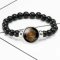 Close-up of black beaded stretch bracelet with Arabic calligraphy glass cabochon - Black