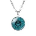 Detail shot of a silver necklace with an Arabic calligraphy glass cabochon pendant - Black Cyan Calligraphy